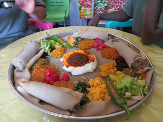 Lunch, Ethiopian style. This is how they serve injera - the teff based pancake like "bread" - on a big plate for sharing, topped with little mounds of different things. They were in a period of fasting when we were there - 40 days before their Christmas celebration, called Timket. So these are all veggie based. Looks odd, but was REALLY good. Yum. 